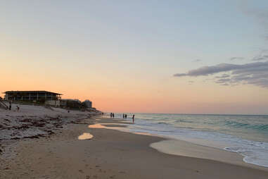 a pristine beach lined with a single hotel