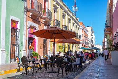 Busy outdoor restaurants on a colorful pedestrian street