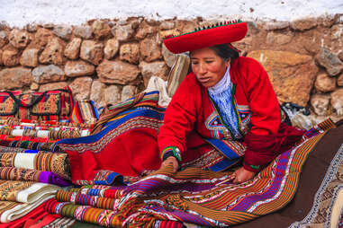Peruvian woman selling souvenirs at Inca ruins