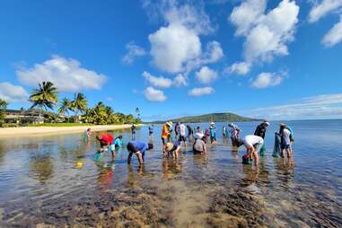 People cleaning up trash at Maunalua Bay, O’ahu