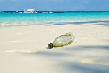 a washed up plastic bottle on the beach