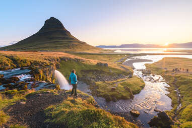 Man admiring the sunrise at mount Kirkjufell, Iceland