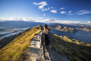 A woman walks down the trail on the Roy’s Peak hike