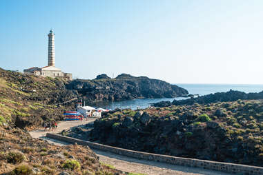 Al faro beach on Ustica Island with lighthouse in background