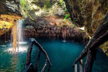 a ladder leading into an underground natural pool