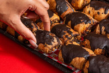 Hand eating from tray of rugelach