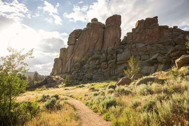 a path past an enormous, unusual rock formation