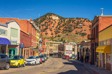 colorful desert town with Mountains and a large B on a hill in the background