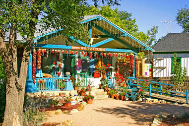 path leading to a quaint and colorful roadside shop