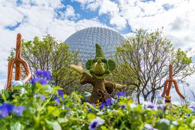 mickey mouse topiary in front of the EPCOT globe