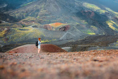 Young woman hiking on Etna volcano