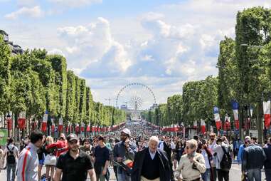 ferris wheel and crowds on the Champs Élysées in Paris on Bastille Day