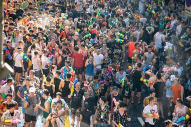 crowds of people having a water gun fight