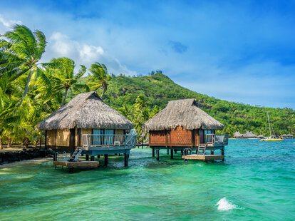 View of turquoise lagoon with thatched huts