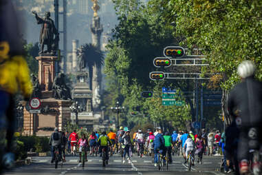 People riding bicycles on Reforma avenue in Mexico City