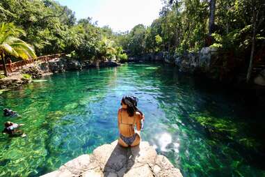 Escape the Touristy Traps with These Adventures in Tulum - Thrillist 3 Woman in bikini on the side of a pool of water