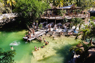 Escape the Touristy Traps with These Adventures in Tulum - Thrillist 4 Club full of people in a large pool of water