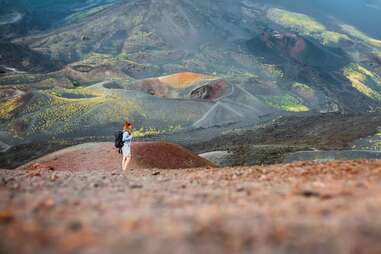 Young woman hiking alone on Etna volcano