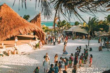 Escape the Touristy Traps with These Adventures in Tulum - Thrillist 8 People on the beach next to thatched hut