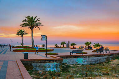 Urban sunset scene at beachfront square