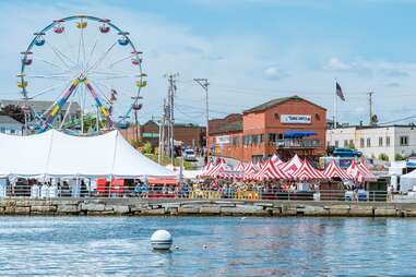 ferris wheel and festival tents on a harbor