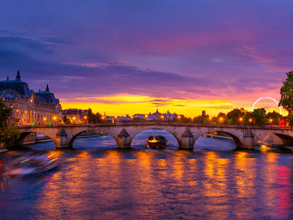Sunset view of Seine river behind bridge