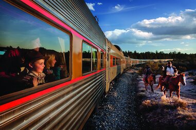 Children on a train look our the window at bandits on horseback