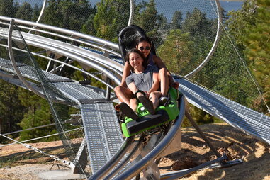 2 people on a rollercoaster at Canyon Coaster Adventure Park