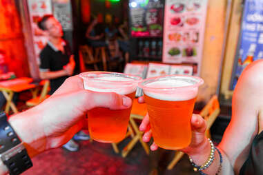 People raise glasses of Vietnamese beer