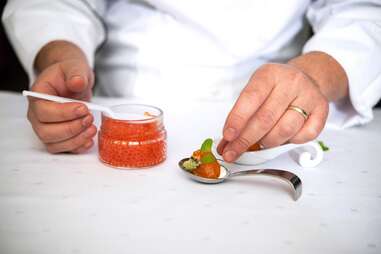 A chef prepares a caviar dish