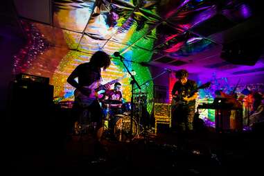 a rock band on stage in a dark venue