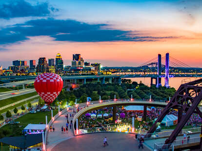 hot air balloon and city skyline near a music festival