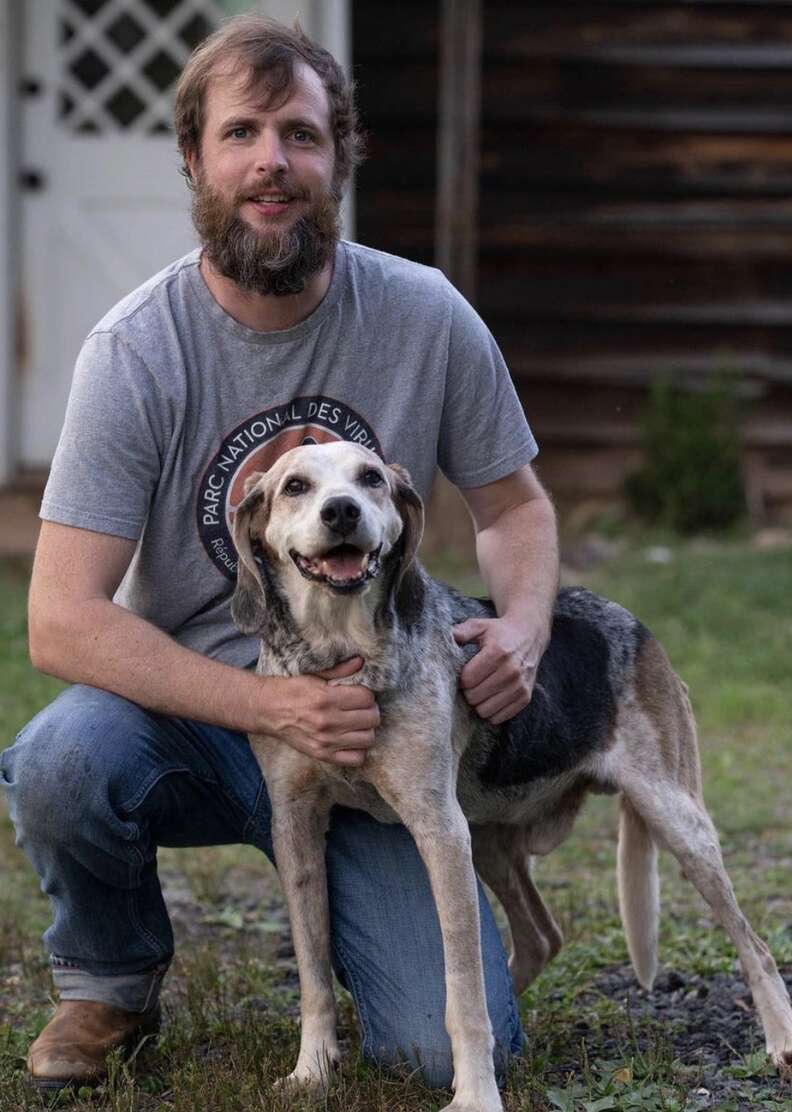 Dog and dad pose for a picture together.