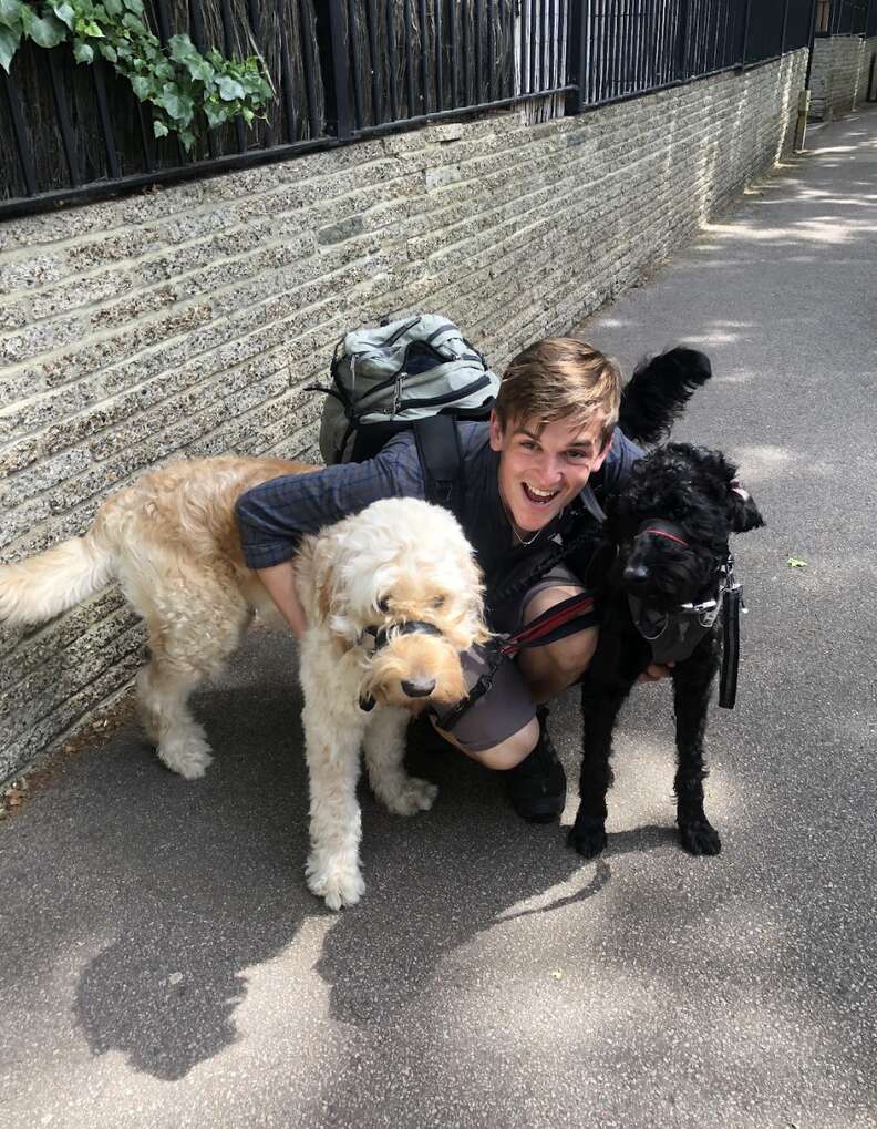 Dog walker poses with two dogs.