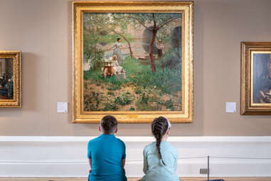 children looking at a museum painting