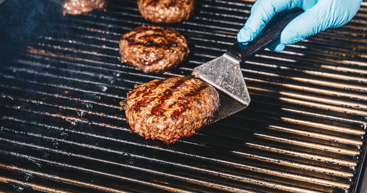 Cooking hamburgers shop on charcoal grill