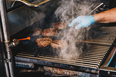 flipping burgers on a grill 