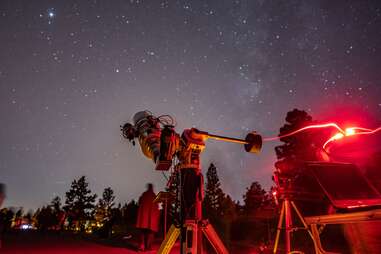 telescope pointing at a starry sky in flagstaff, arizona