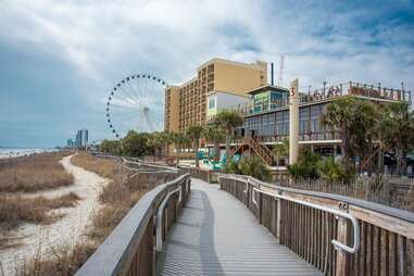 boardwalk leading to ferris wheel in myrtle beach, south caroline