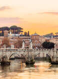 Rome skyline at sunset with Tiber river and St. Peter's Basilica