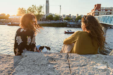 two women hanging out by river in montreal