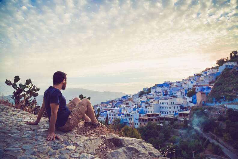 Tourist observing a panoramic view of Chefchaouen
