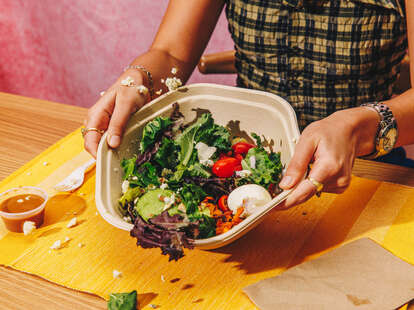 tossing a sweetgreen salad
