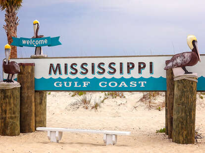 Welcome to Mississippi Gulf Coast sign on sandy beach in Gulfport