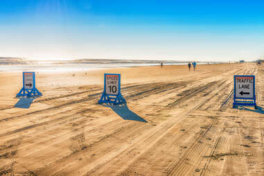 road signs on a beach in daytona beach, florida