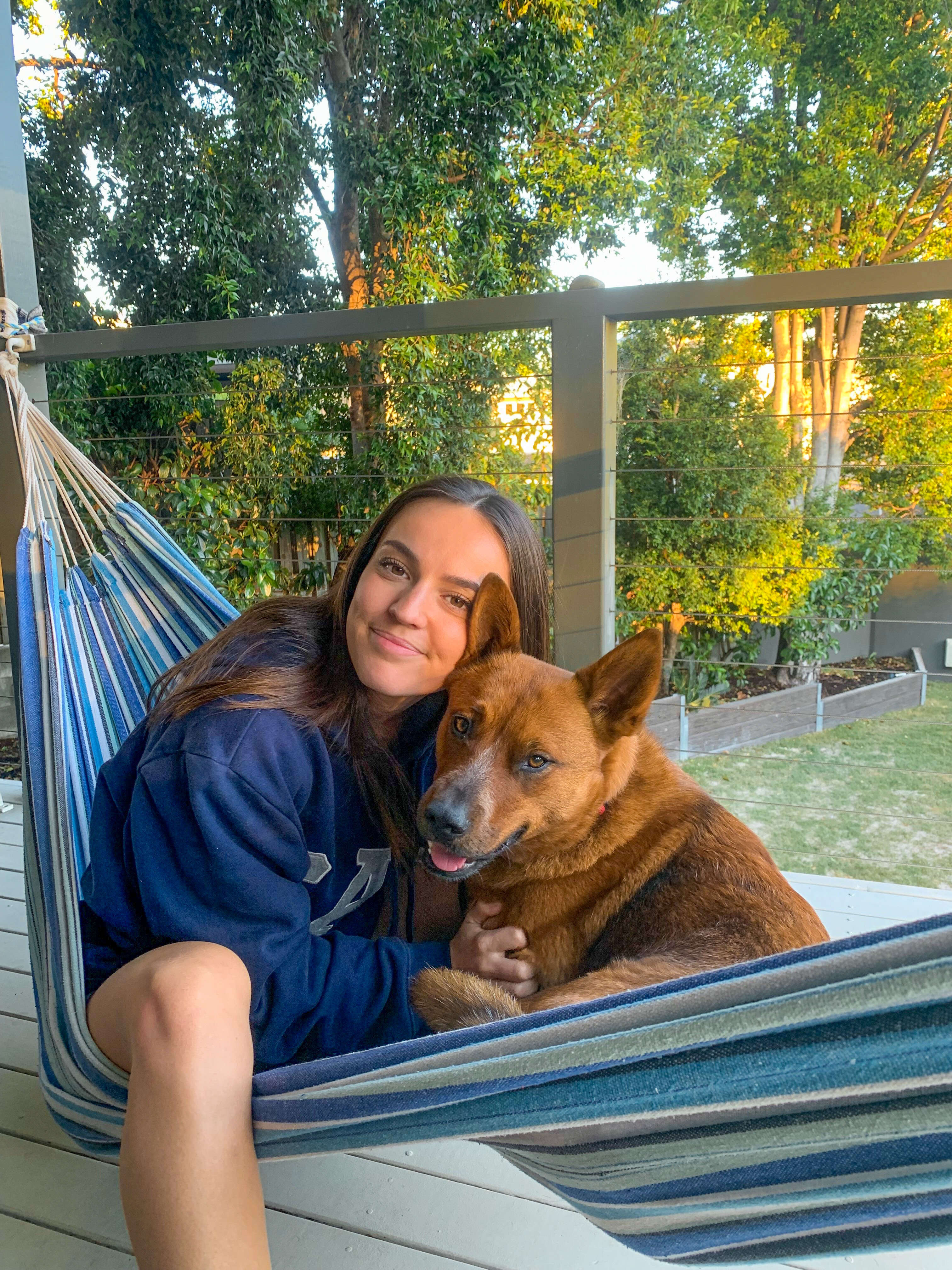 girl and dog in hammock