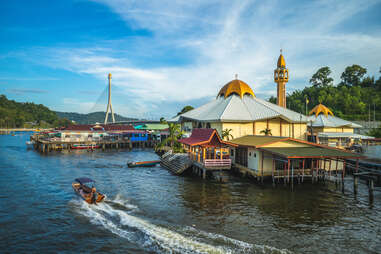 Kampong Ayer water village with boat nearby