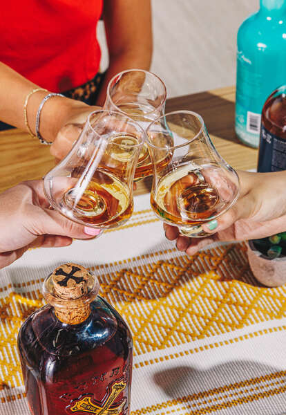 clinking glasses filled with rum