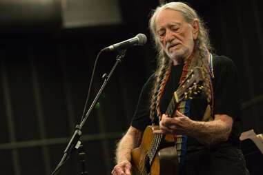 WIllie Nelson playing guitar