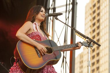 Kacy Musgraves playing guitar